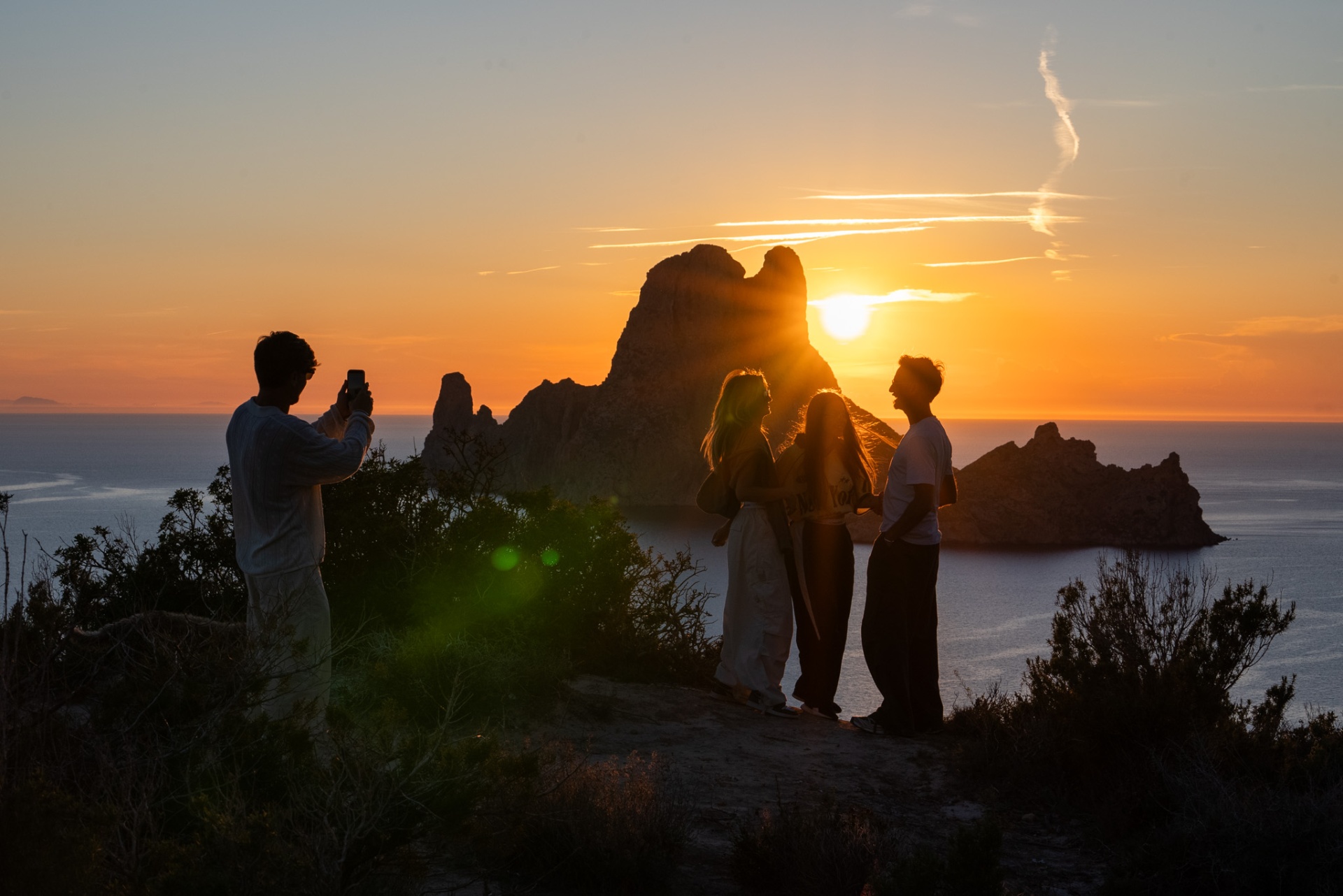 Woweee Sunset, friends watching Es Vedrà glow at golden hour