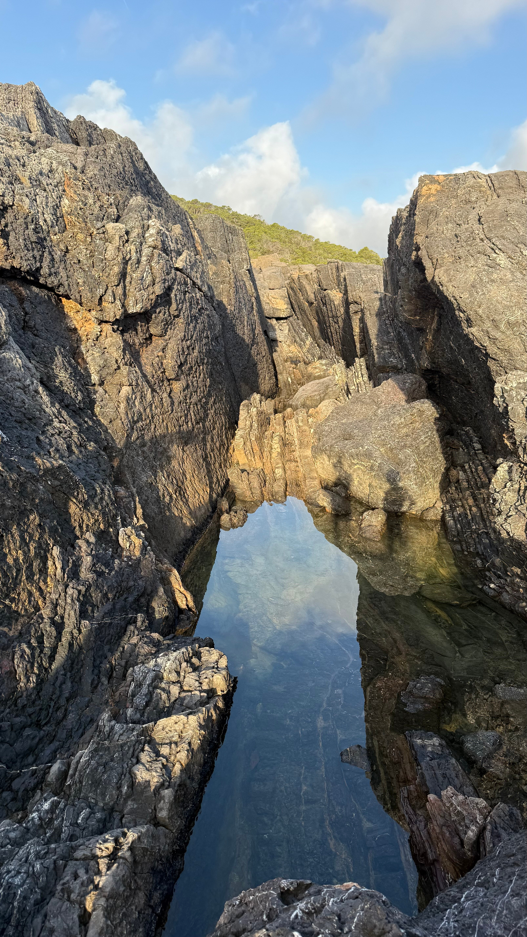 Mirror-still pool inside a slot canyon, Island Canyons
