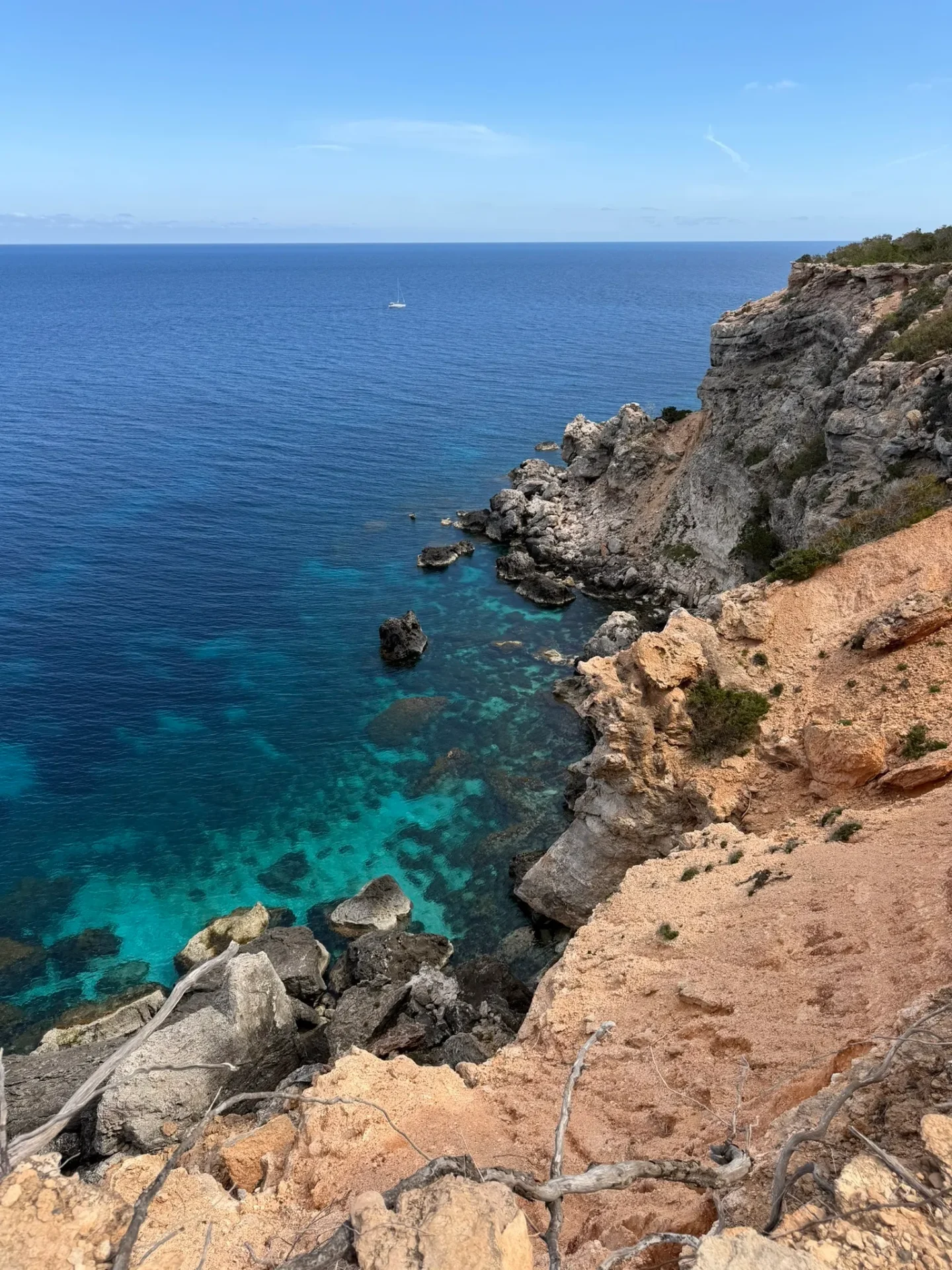 Tower of Light, cliffside view of crystal-clear sea and rocky shoreline
