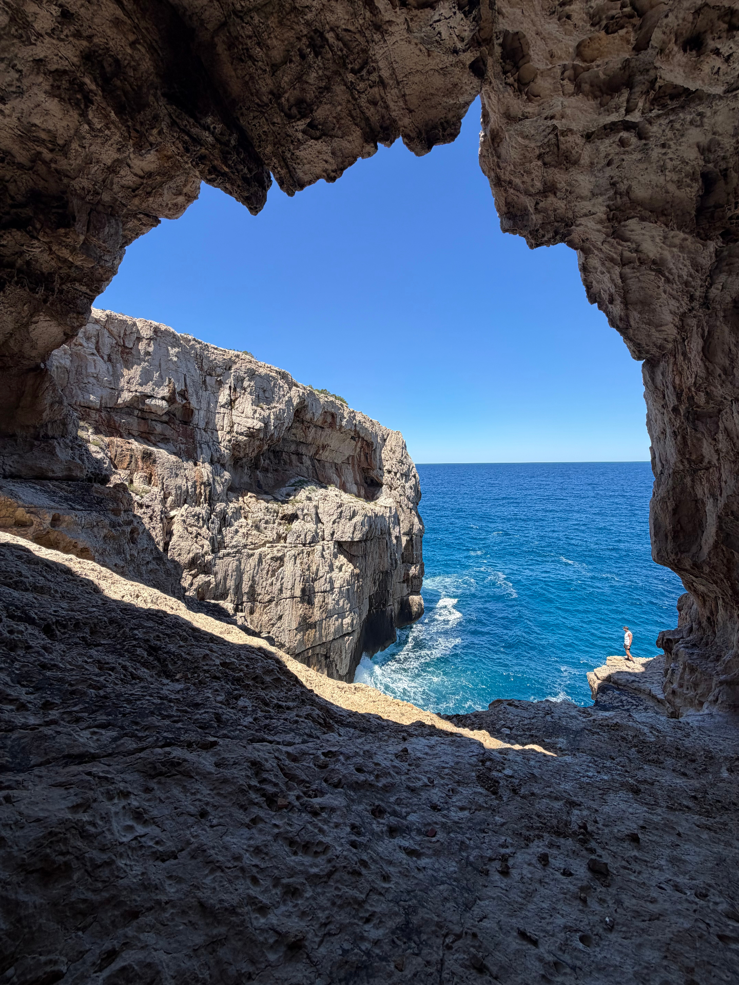Jurassic Cave, sea view framed by the mouth of a dramatic limestone cave