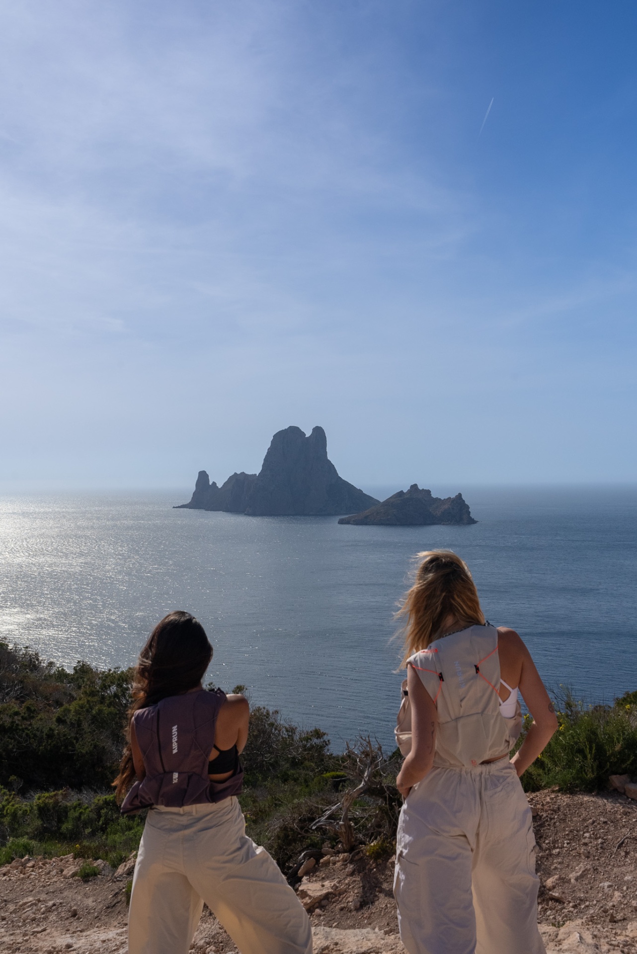 Queen of Hikes, hikers gazing out at Es Vedra rising from the sea