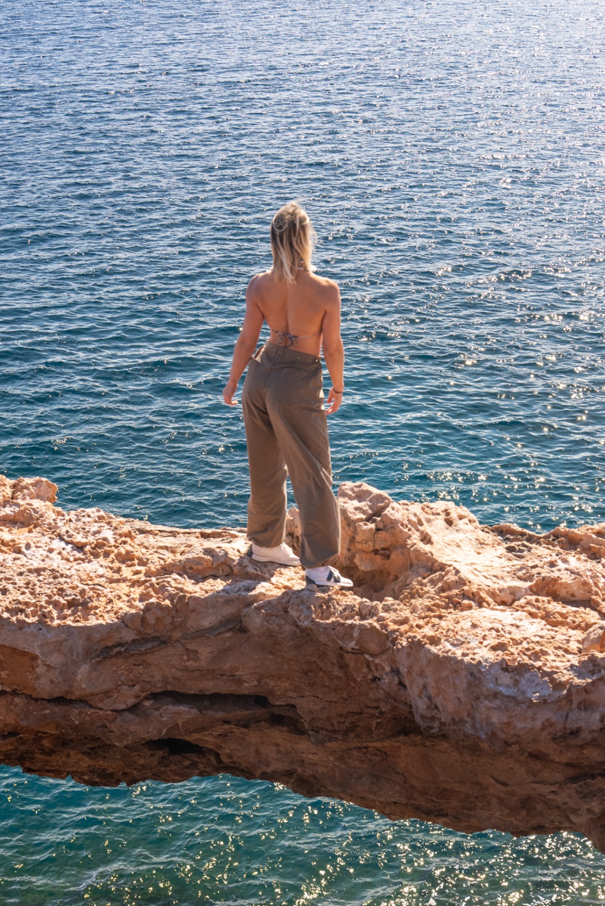 Lunar Dreams, standing on a rock above the shimmering sea